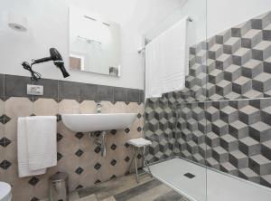 a bathroom with a sink and a toilet and a mirror at La Locanda di Cucco in Finale Ligure