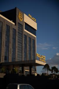 a building with a sign on top of it at Palace Hotel & SPA in Mitrovicë