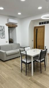 a living room with a table and chairs and a couch at Antica Capri B&B in Naples