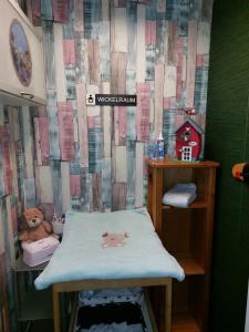 a small childs room with a bed and a wall at Westwind in Eggstedt