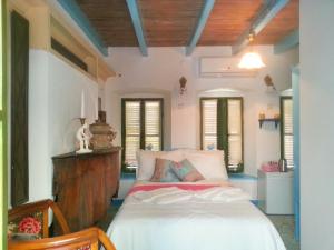 a bedroom with a bed in a room with windows at Cemil İpekçi Pension in Bodrum City