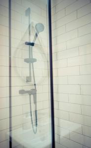 a shower in a bathroom with a glass wall at Apartament przy Rynku in Sanok