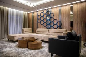 a living room with a couch and a coffee table at Palace Hotel & SPA in Mitrovica