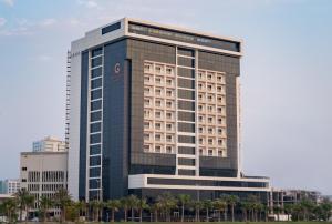 a large building with a large clock on it at The Grove Hotel & Conference Centre Bahrain in Manama