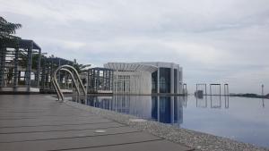 a large building next to a body of water at Prestige Troika Luxury Stay in Kota Bharu