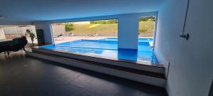 a view of a swimming pool through a large window at Apartamento frente al mar primera linea de la mansa Pda 26 punta del este penthouse in Punta del Este