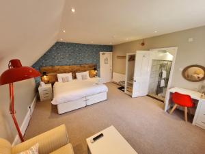 a large bedroom with a bed and a bathroom at The Randolph Hotel in Southwold