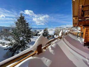 a snow covered fence next to a house at Chalet Sempre Més in Font-Romeu-Odeillo-Via