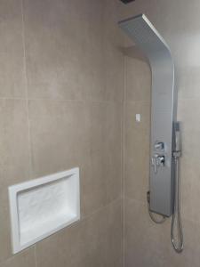 a shower with a shower head in a bathroom at Casa Amigable y Disfrutable in La Coronilla