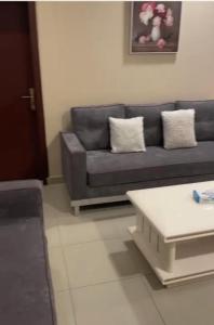 a living room with a couch and a coffee table at شقق المربعة للشقق المخدومة in Ruqaiqah