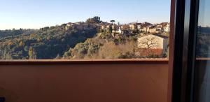 a view of a mountain from a window at A CASA DEL SOLE in Palaia