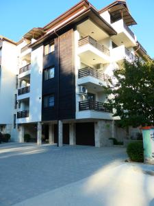a large apartment building with a parking lot at Nikol 2 Deluxe in Velingrad