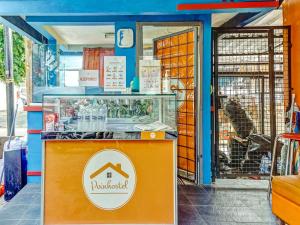 a dog is sitting inside of a pet shop at Super OYO 90692 Point Hostel in Jakarta