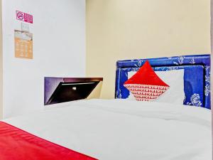 Un ou plusieurs lits dans un hébergement de l'établissement Super OYO 90692 Point Hostel