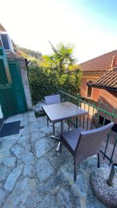 a picnic table and chairs on a stone patio at Casa Portofino in Camogli