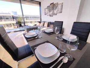 a dining room with a table and chairs with a view of a room at Panorama Apartment Vienna - free parking, sauna & fitness in Vienna