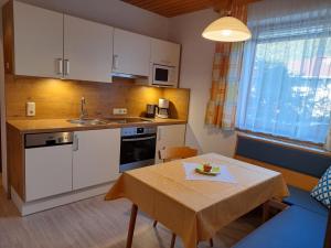 a kitchen with a table and a table and a dining room at Haus Gappmaier in Filzmoos