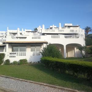 a large white house with a green yard at OCEAN TERRACES by VILA GAIVOTA D in Ferragudo