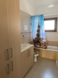 a bathroom with a toilet and a shower curtain at Two bedroom Duplex :Mountain and Sea view in Larnaca +19 photos