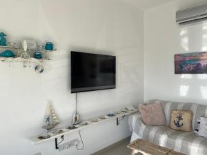 a living room with a flat screen tv on a wall at Two bedroom Duplex :Mountain and Sea view in Larnaca