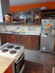 a kitchen with a stove and a refrigerator at Casa cerca del microcentro y costanera in Posadas
