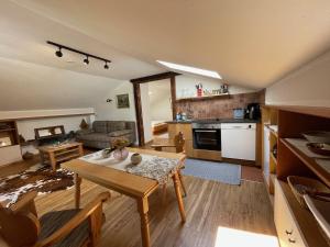a kitchen and a living room with a table and chairs at Haus Lukaswinkl in Schönau am Königssee