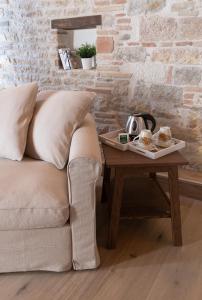 a living room with a couch and a coffee table at Residenza Donna Iohanna in Gubbio
