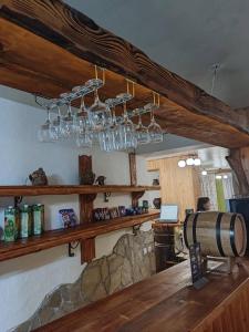a bar with a wine barrel and chandeliers at Girskiy Prutets in Bukovel