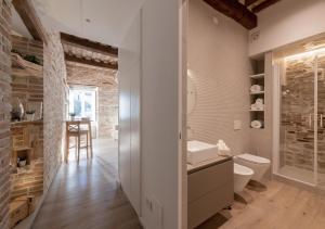 a bathroom with a sink and a toilet in a room at Residenza Donna Iohanna in Gubbio