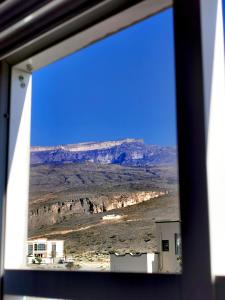 a view of the desert from a window at 228Hostel in Al Ḩamrāʼ +141 photos