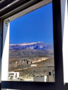 a view of the desert from a window at 228Hostel in Al Ḩamrāʼ