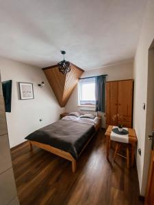 a bedroom with a large bed and a table at U Maćka in Białka Tatrzańska +46 photos