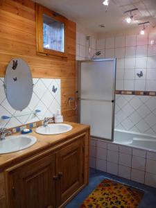 a bathroom with two sinks and a refrigerator at Chez Michel in Sainte-Foy-Tarentaise