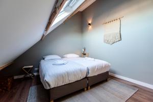 a bedroom with a large bed in a attic at Spacious Luxury Loft in Zandvoort