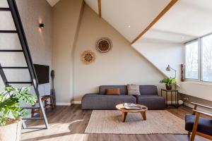 a living room with a couch and a table at Spacious Luxury Loft in Zandvoort