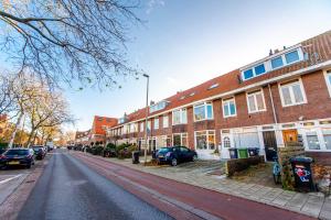 an empty street with cars parked in front of buildings at Spacious Luxury Loft in Zandvoort