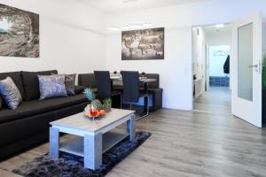 a living room with a couch and a table at Relax-Apartment mit Indoor-Pool, Sauna, Massagesessel und Netflix in Schonach