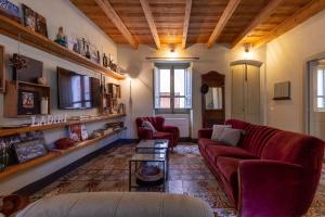 a living room with a couch and two chairs at Ladiri - Antica dimora in terra cruda in Sìnnai