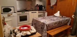 a small kitchen with a table and a sink at Valloire Studio Marmotte : Nid douillet centre de valloire, été / hiver 4p in Valloire