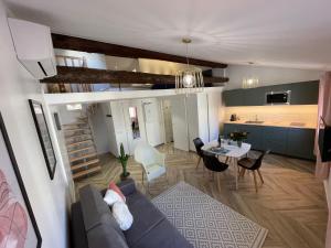 a living room with a couch and a table at Nice Renting - MASSENA - LOFT - HEART of VIEIL ANTIBES - THE MARKET WITH SEA VIEW in Antibes