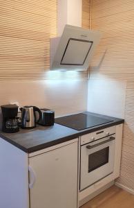 a kitchen with a counter with a stove top oven at Myplace in Oulu Studio Koulukatu in Oulu