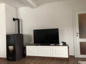 a flat screen tv sitting on top of a white cabinet at Guest house Elena in Mojkovac