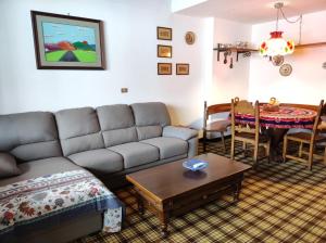 a living room with a couch and a table at La finestra sul Matese in San Massimo