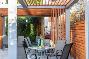 a patio with a table and chairs and a fence at Willa Albatros Happy Hours in Gdańsk