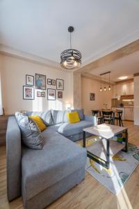 a living room with a couch and a table at Bella Gondola Zlatibor in Zlatibor +19 photos