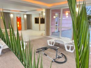a room with a gym with a treadmill and chairs at Aqua Wellness Apartments in Hajdúszoboszló +26 photos