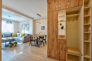 a living room and dining room with a wooden door at Bella Gondola Zlatibor in Zlatibor