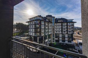 a view of a building from a balcony at Bella Gondola Zlatibor in Zlatibor