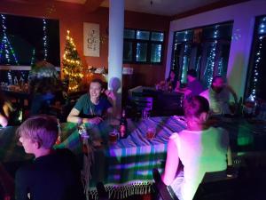 a group of people sitting in a bar with a christmas tree at Guesthouse Panorama in Beruwala