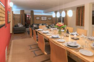 a large dining room with a long table and chairs at Chalet Gamskar in Sankt Anton am Arlberg